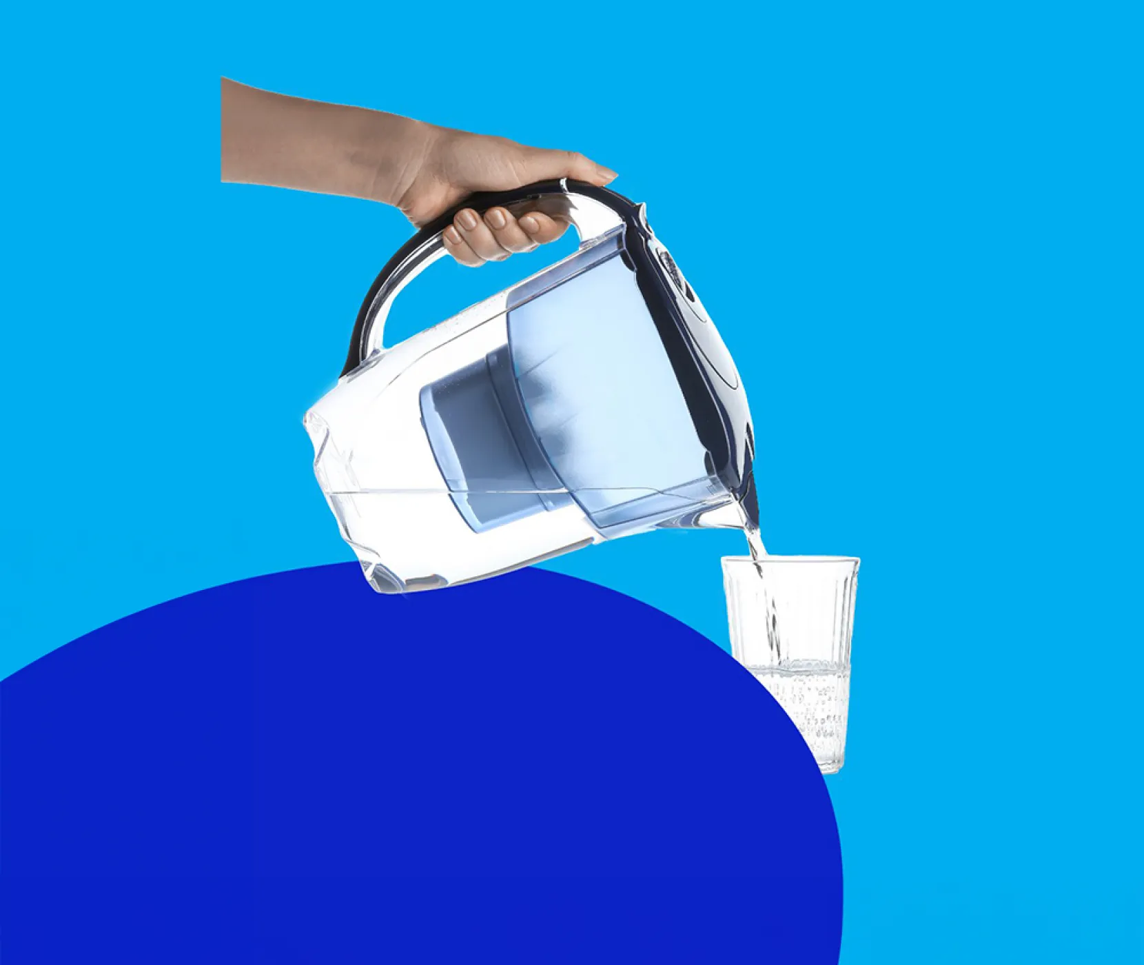 A person pouring water into a glass using a water filter