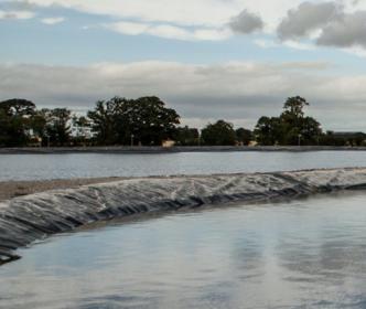 A large body of water being filtered through black fabric