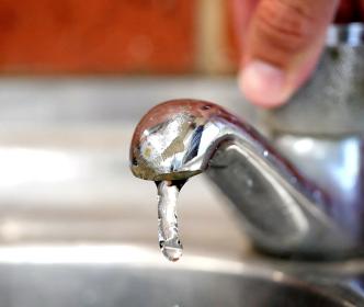A household tap being turned on so water flows