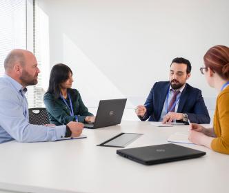Four people having a meeting in a room