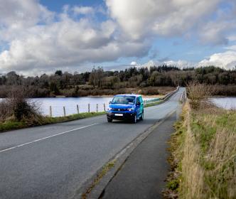 Uisce Éireann Blue green van on open road 