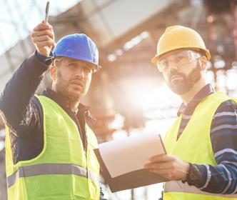 two Uisce Éireann workers pointing at something on site 