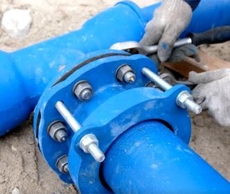 A worker fixing a water main
